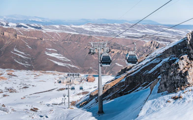 Ski lifts ascending Shahdag mountain resort on a sunny winter day, Baku.