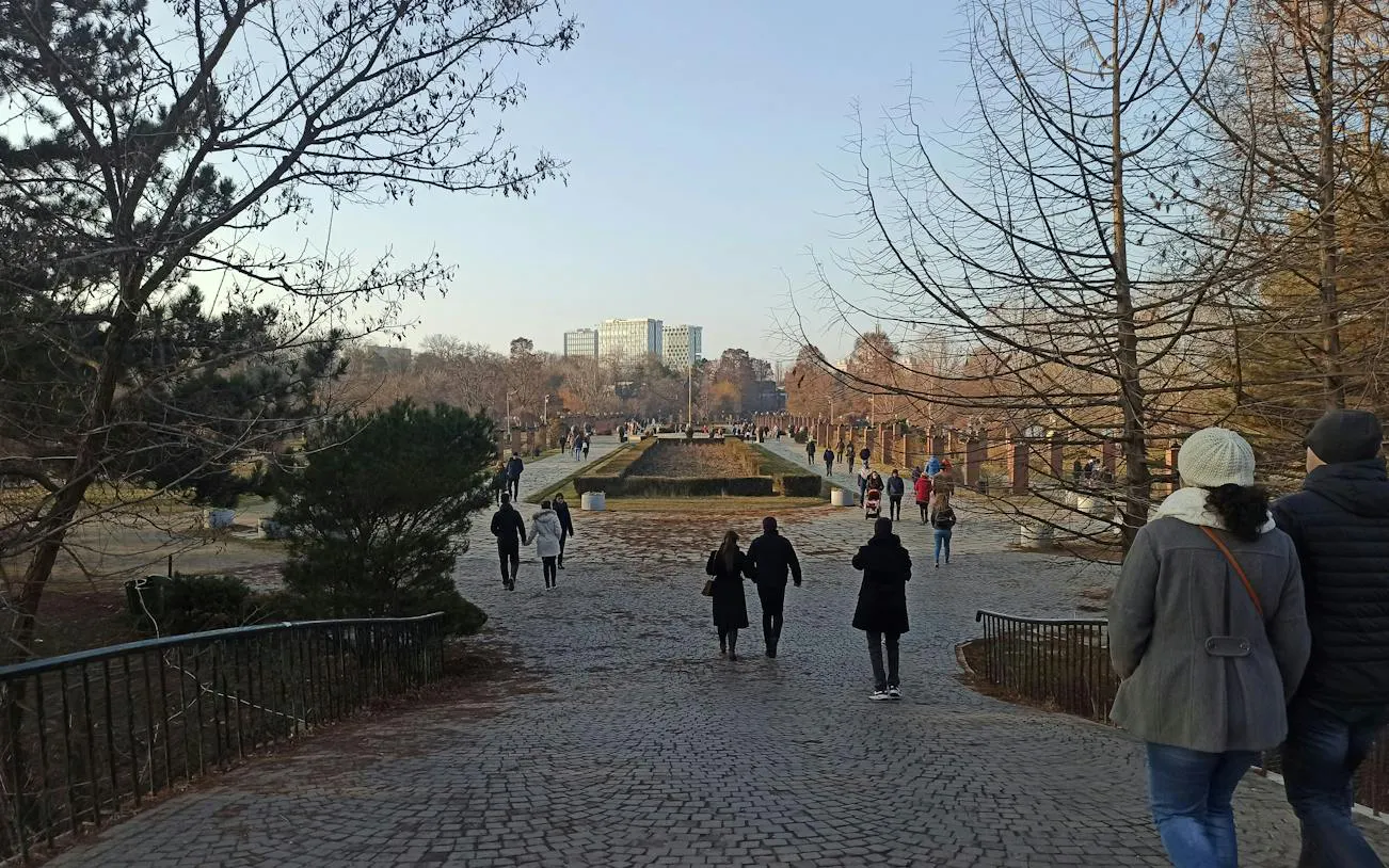 Couples walking in a park during the Romantic Bucharest self-guided city exploration game.