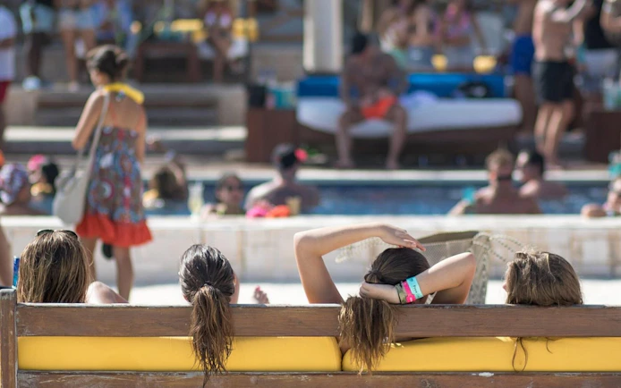 People relaxing by the pool at Mandala Beachclub Cancun.