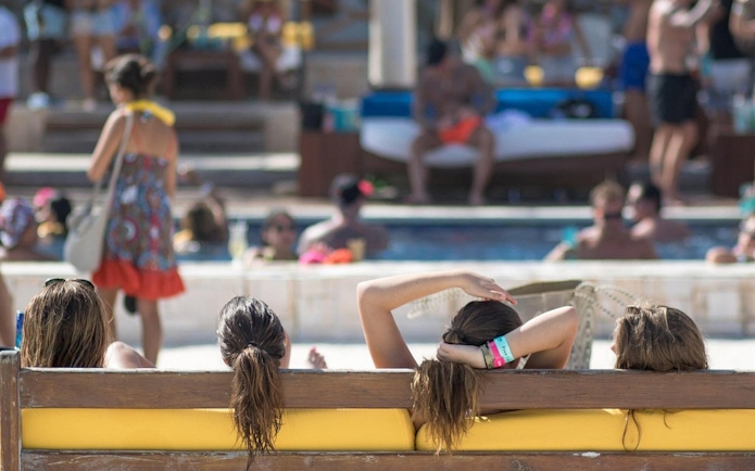 People relaxing by the pool at Mandala Beachclub Cancun.