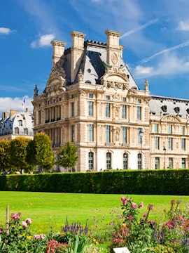 Louvre Museum building with gardens in Paris, France.
