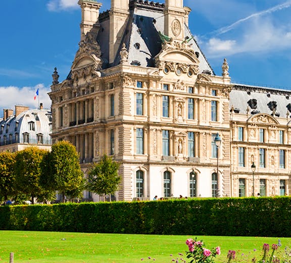 Louvre Museum building with gardens in Paris, France.