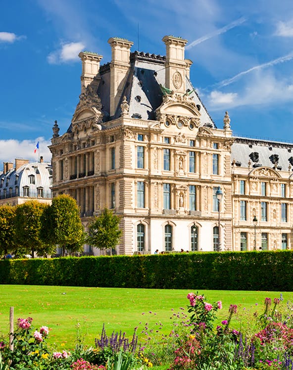Louvre Museum building with gardens in Paris, France.