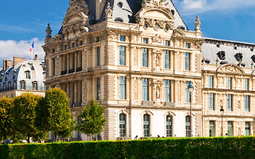 Louvre Museum building with gardens in Paris, France.
