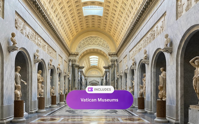 Vatican Museum hall with classical sculptures and ornate ceiling, Rome.