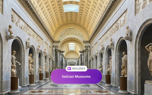 Vatican Museum hall with classical sculptures and ornate ceiling, Rome.