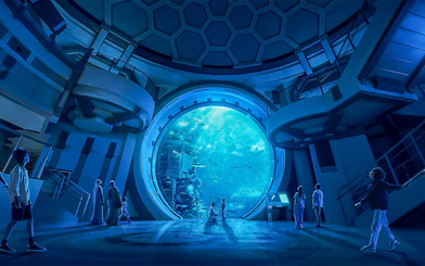 Visitors observing marine life through a large aquarium window at SeaWorld Abu Dhabi.