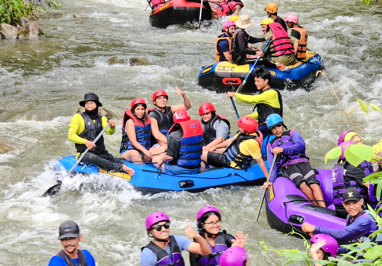 Group enjoying white water rafting on Phang Nga River, Phuket.