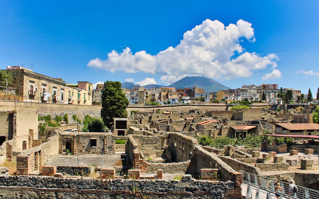 Aerial view of Herculaneum ruins with Mount Vesuvius in the background, Italy.