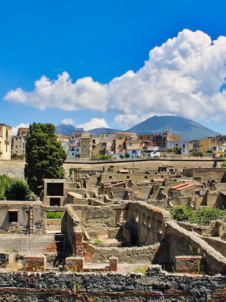 Aerial view of Herculaneum ruins with Mount Vesuvius in the background, Italy.