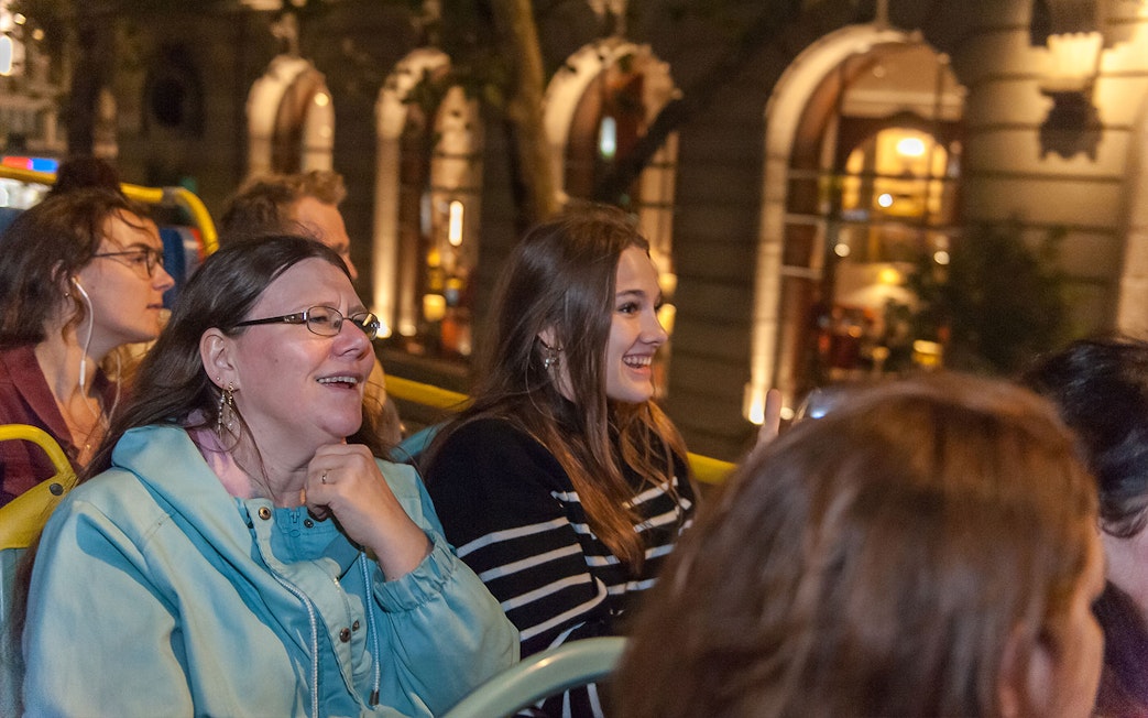 Passengers enjoying Tootbus London evening tour on an open-top bus.