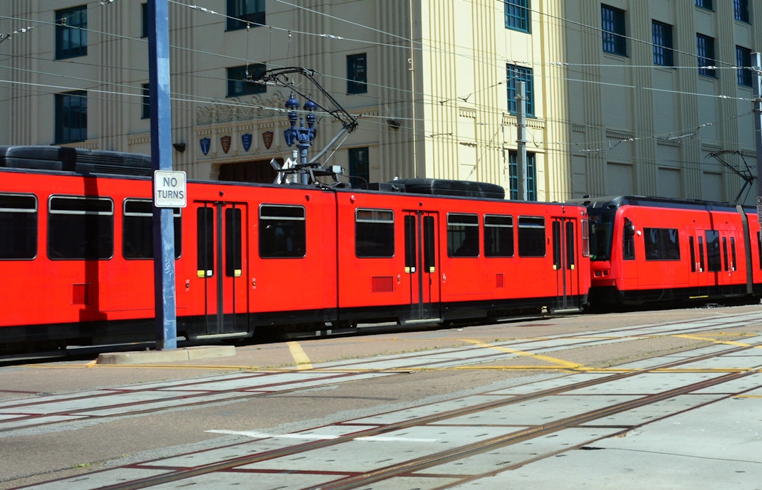San Diego Trolley passing historic Gaslamp Quarter buildings.