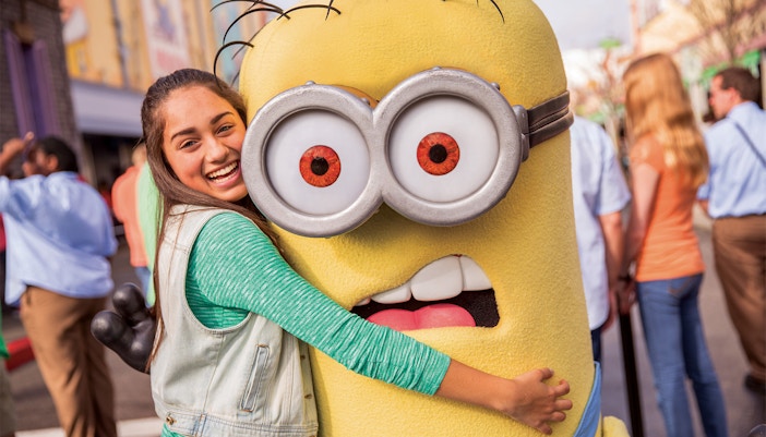 Visitor hugging a Minion character at Universal Studios Hollywood.