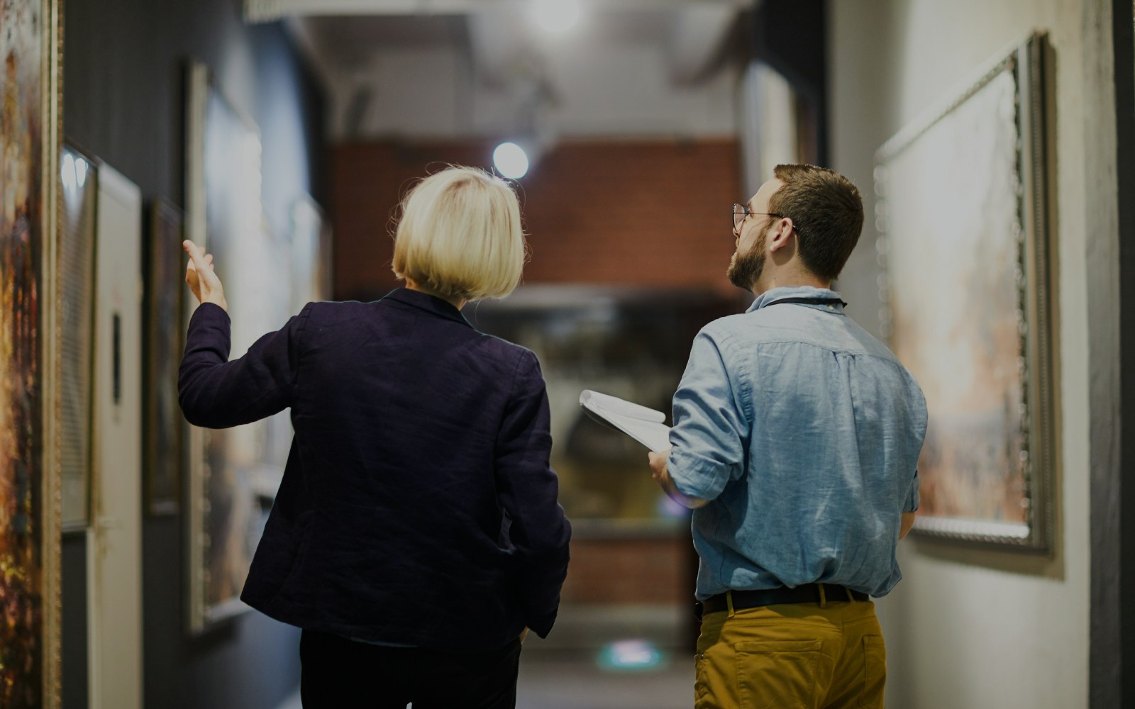 Visitors discussing artwork in a gallery at an art museum.
