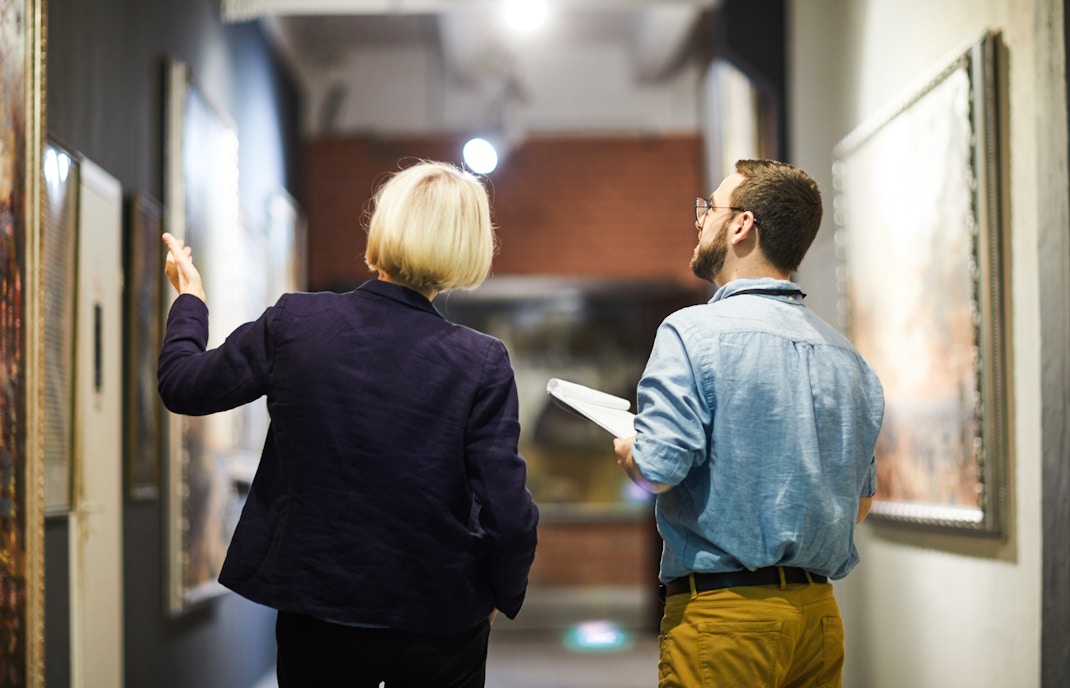 Visitors exploring exhibits at a renowned art museum in a vibrant city.
