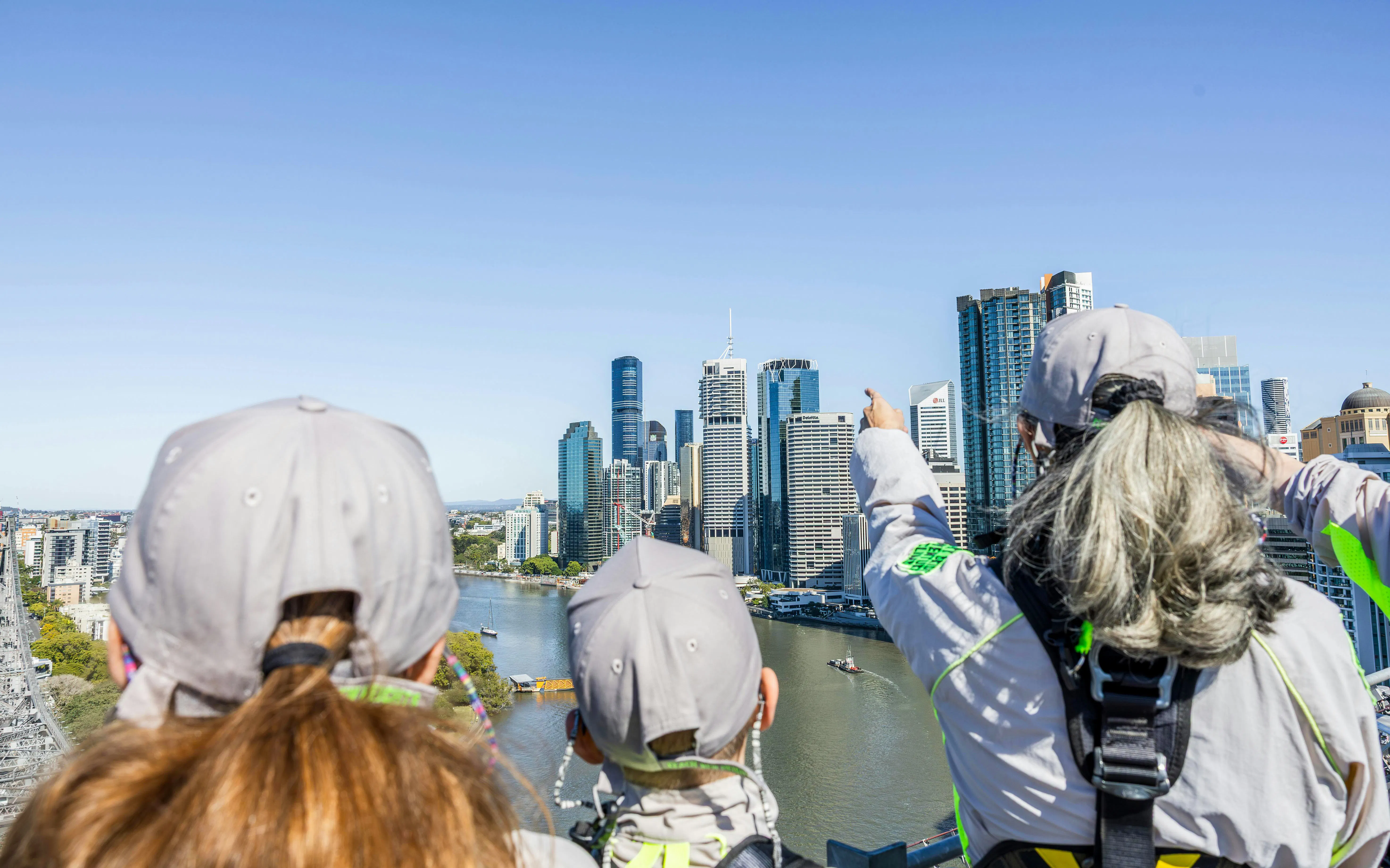 Climbers on Story Bridge Adventure Climb overlooking Brisbane skyline.