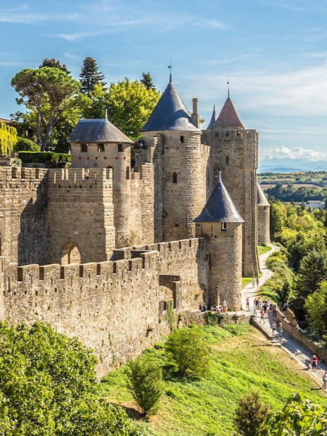 Carcassonne castle ramparts with towers and surrounding landscape.