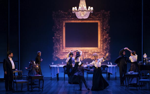 Theater performance in Leopoldstadt with actors dancing under a chandelier.