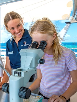 Child using microscope on Cairns school holiday tour.