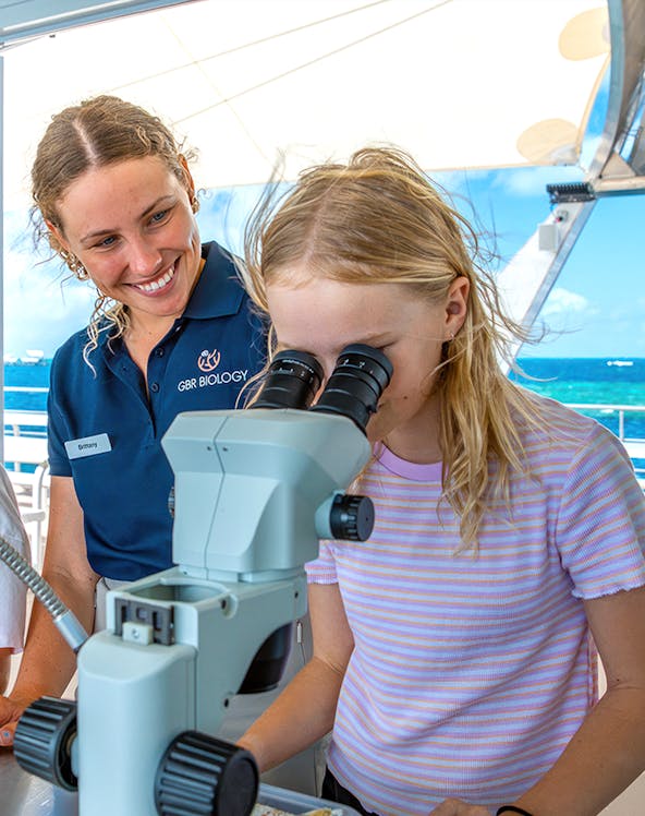 Child using microscope on Cairns school holiday tour.