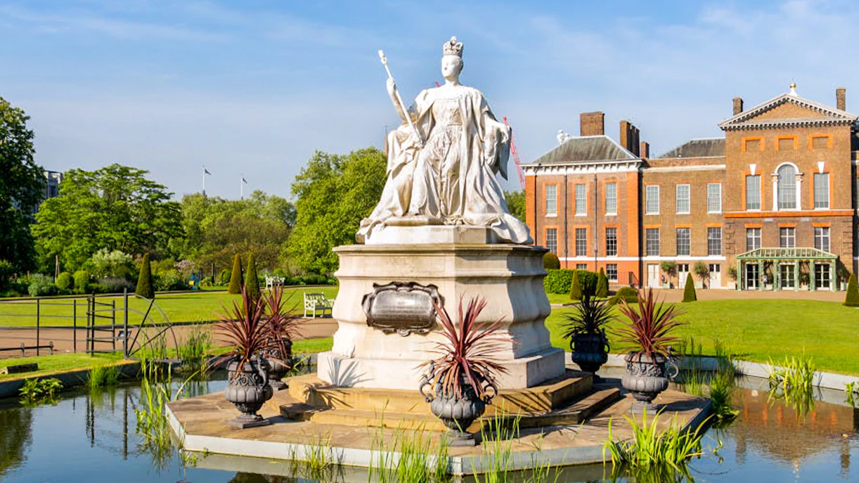 Kensington Palace gardens with statue, London Eye tour tickets available.