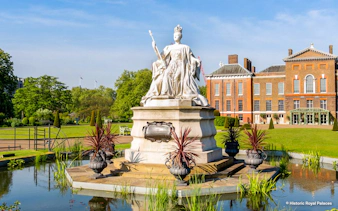 Kensington Palace gardens with statue, London Eye tour tickets available.