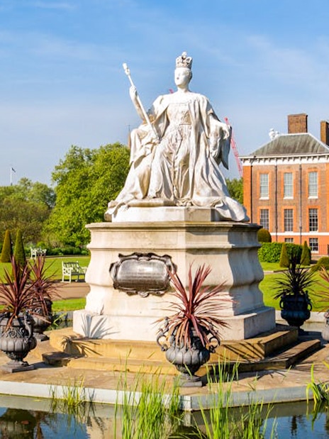 Kensington Palace gardens with statue, London Eye tour tickets available.
