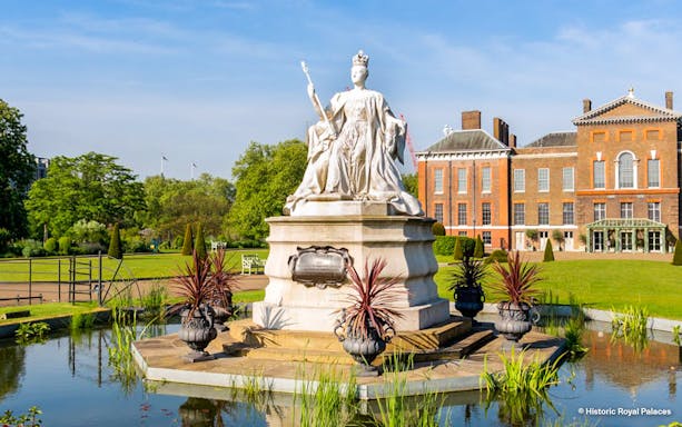 Kensington Palace gardens with statue, London Eye tour tickets available.