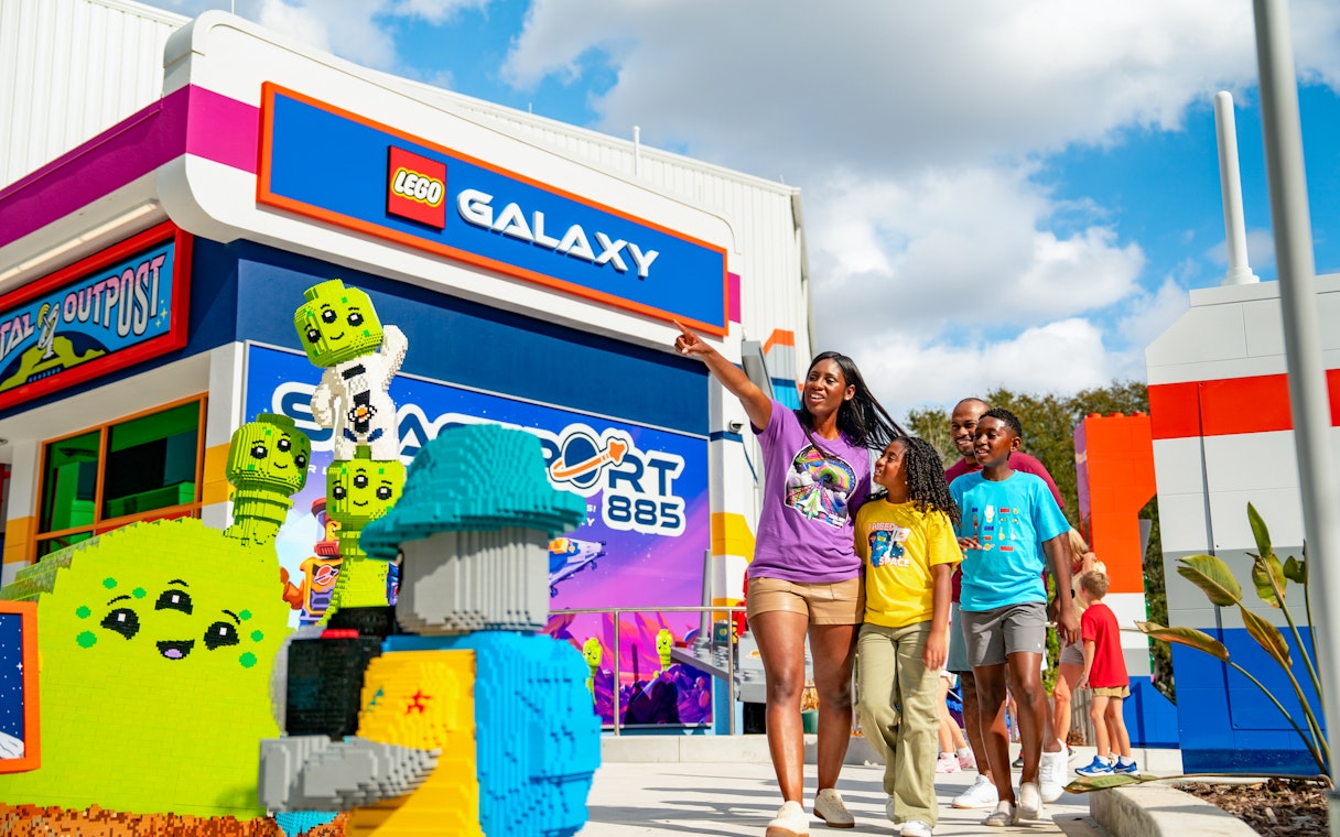 Family exploring LEGO Galaxy area at LEGOLAND California Resort's Galacticoaster.