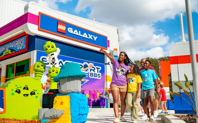 Family exploring LEGO Galaxy area at LEGOLAND California Resort's Galacticoaster.
