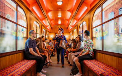 Children on a train during The Paddington Bear Experience in London, enjoying interactive storytelling.