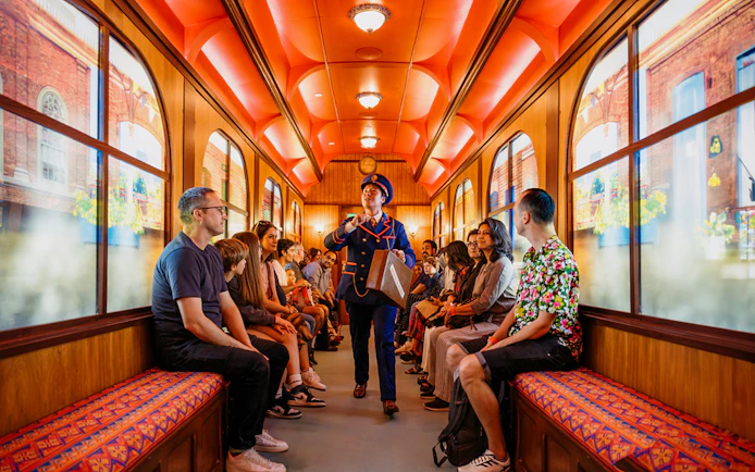 Children on a train during The Paddington Bear Experience in London, enjoying interactive storytelling.