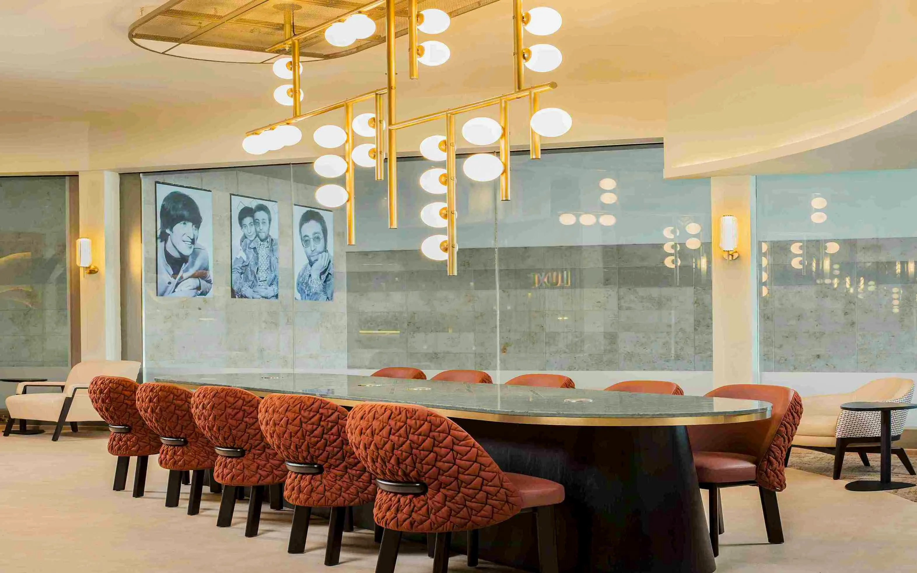 Aspire Lounge seating area with Beatles artwork at John Lennon Airport.