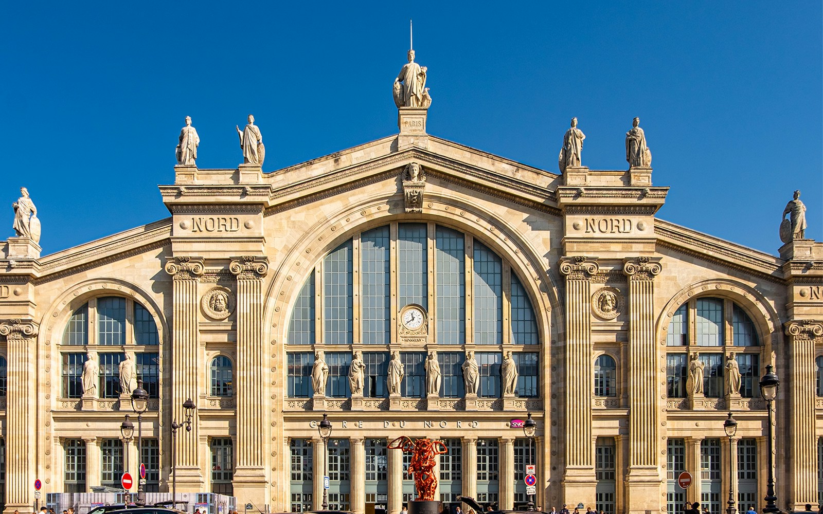 Gare du Nord Railway Station facade in Paris with statues and clock.