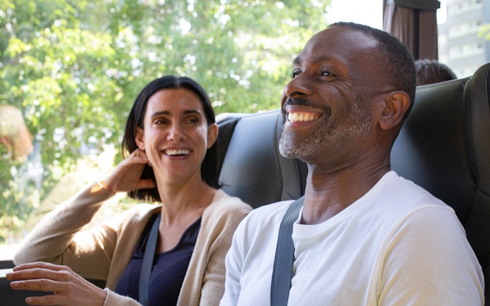 Passengers smiling on a National Express bus ride.