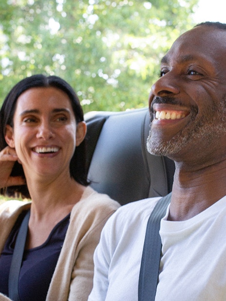 Passengers smiling on a National Express bus ride.