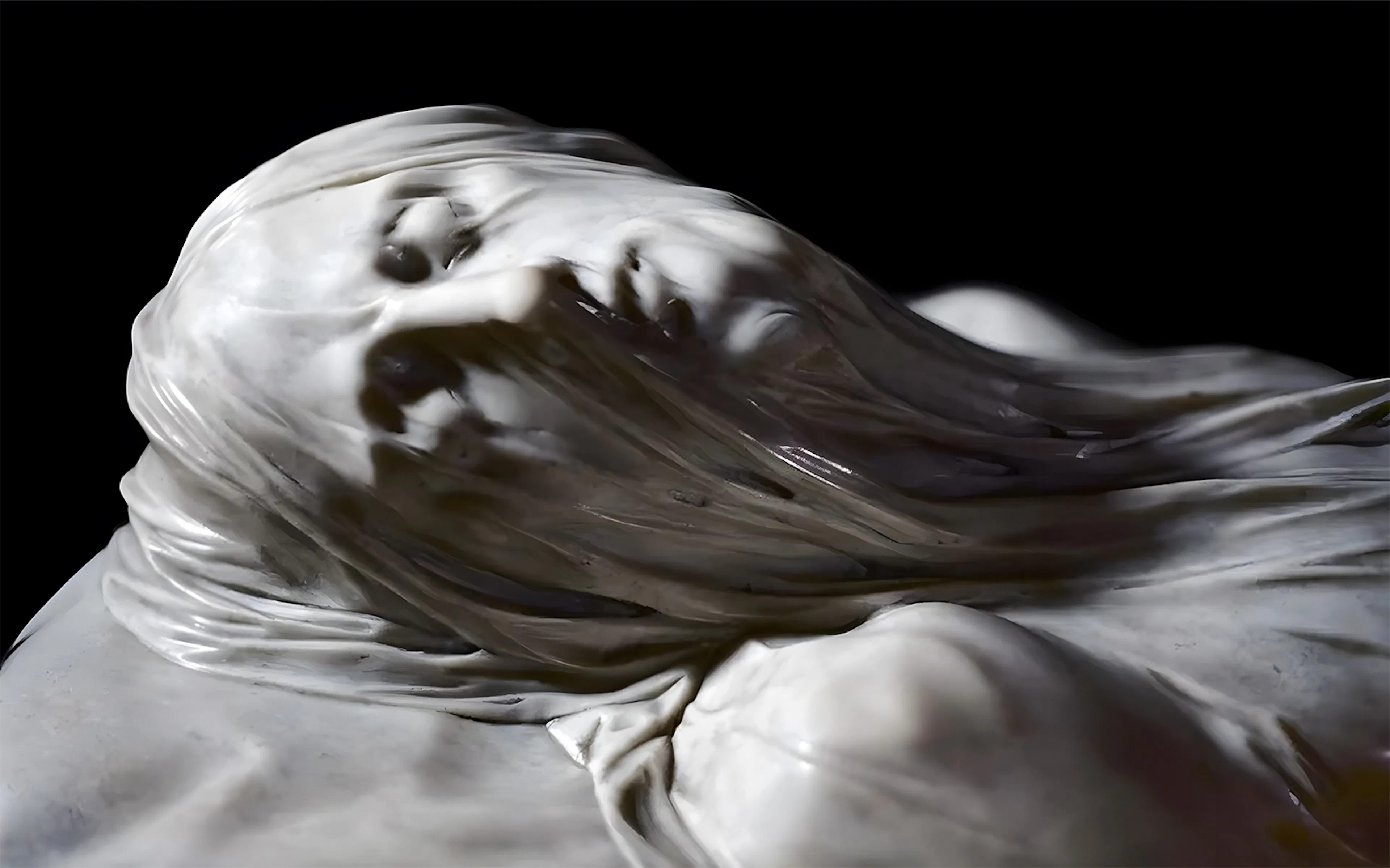 Close-up of the Veiled Christ statue's face, showcasing intricate marble detailing.