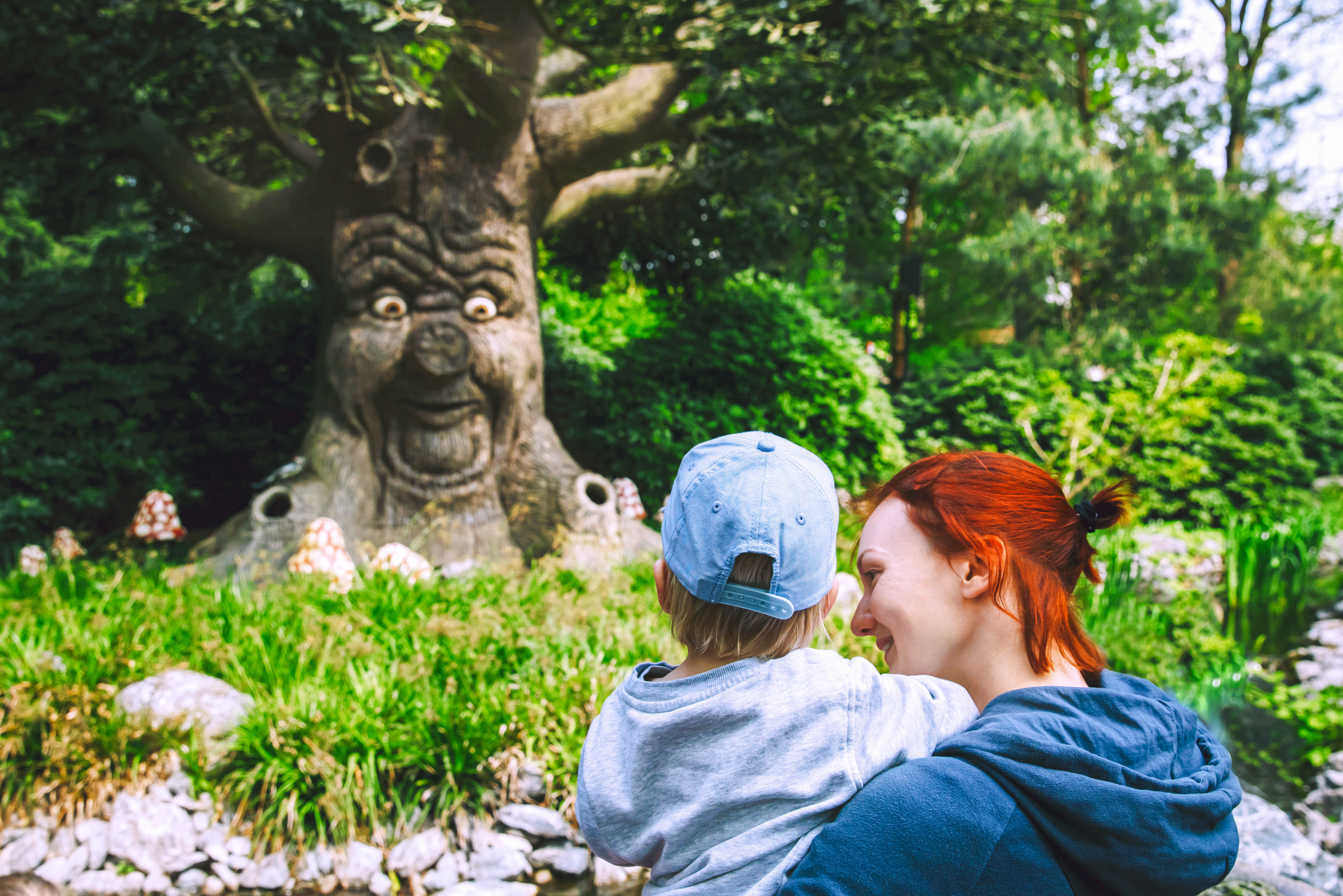 Family enjoying the talking tree attraction at Efteling, Netherlands.