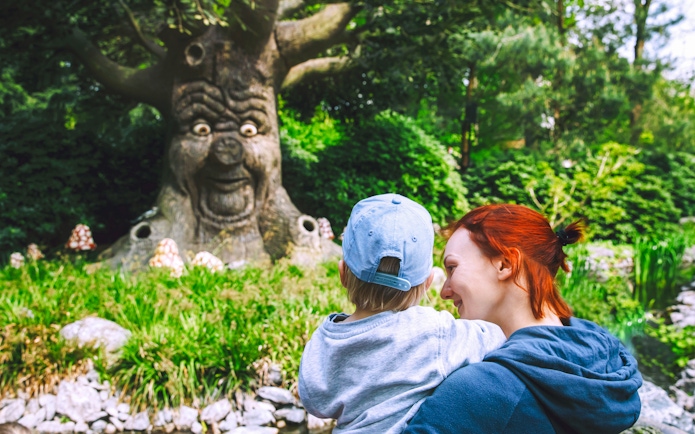 Family enjoying the talking tree attraction at Efteling, Netherlands.