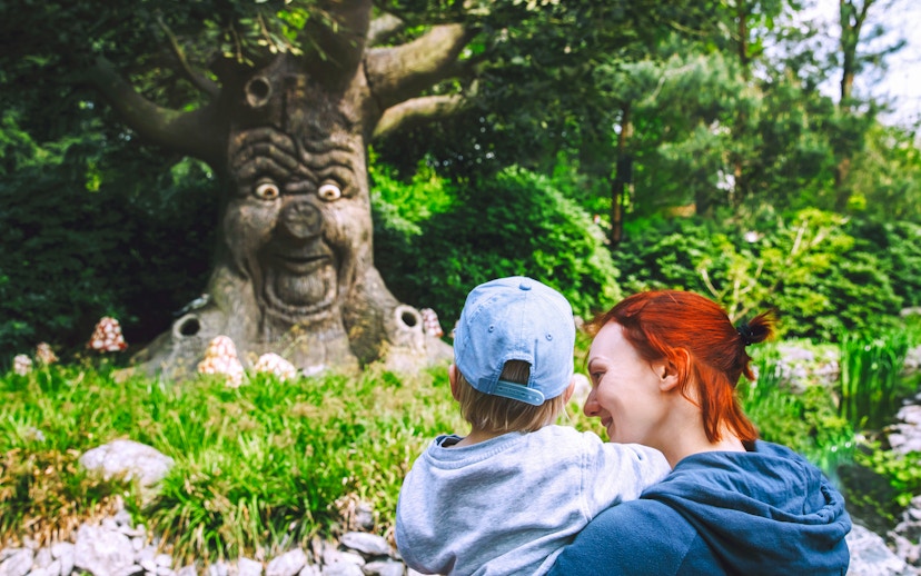 Family enjoying the talking tree attraction at Efteling, Netherlands.
