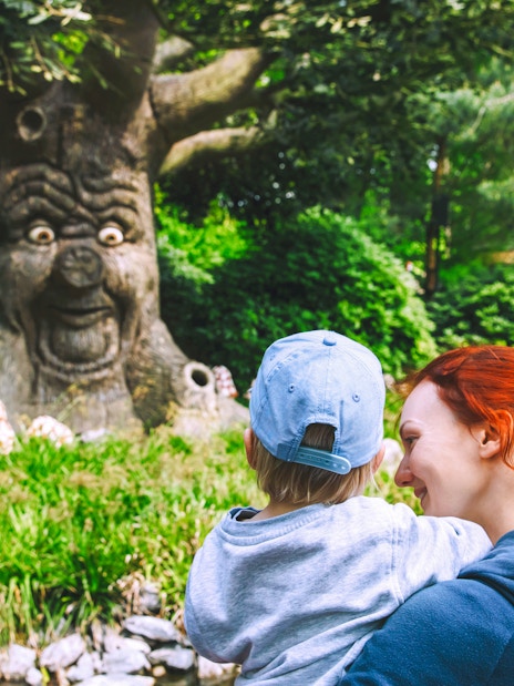 Family enjoying the talking tree attraction at Efteling, Netherlands.