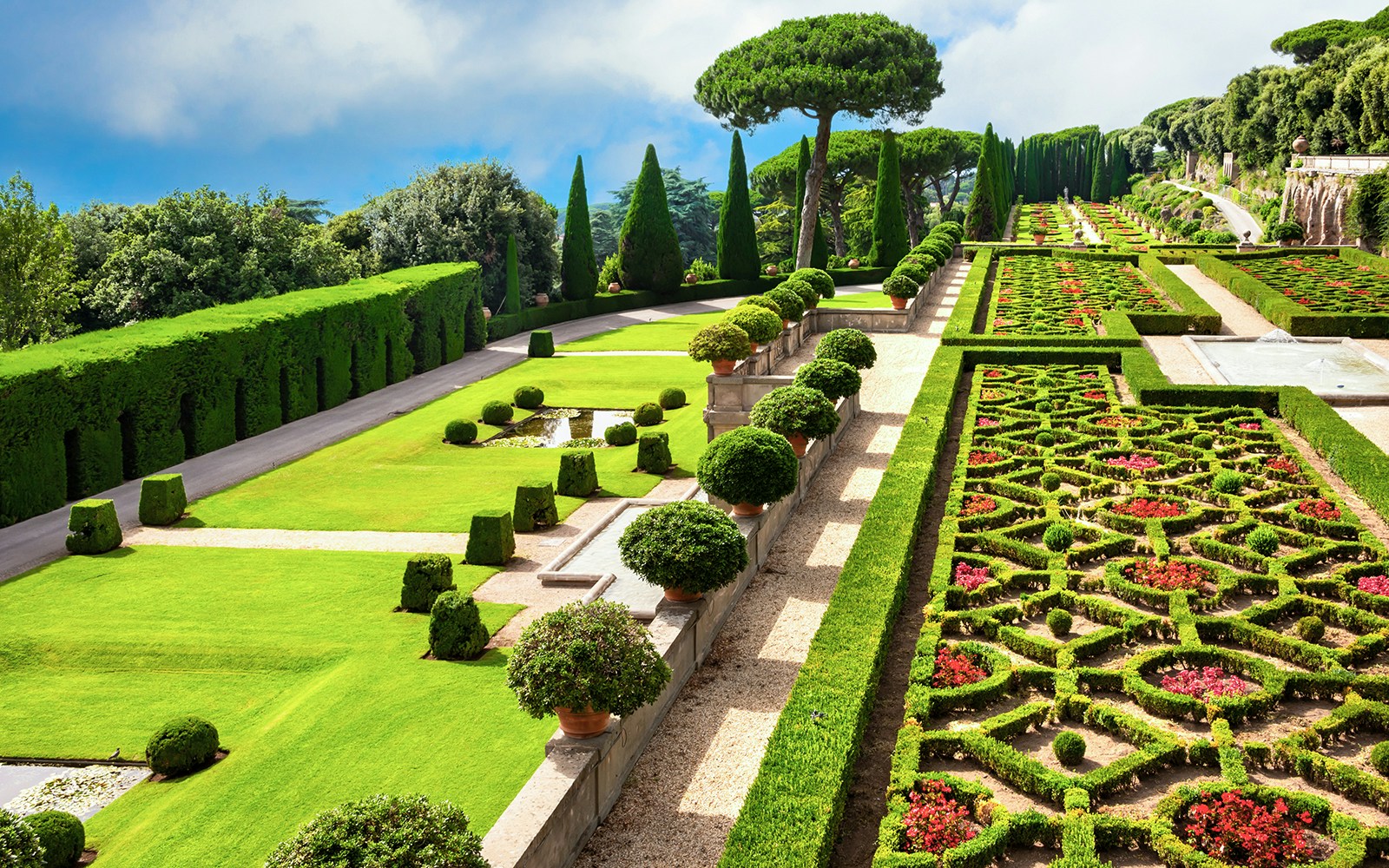 Terraced gardens with hedges and flower beds in Castel Gandolfo park, Italy.