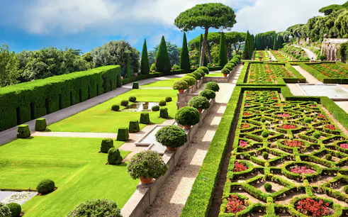 Terraced gardens with hedges and flower beds in Castel Gandolfo park, Italy.