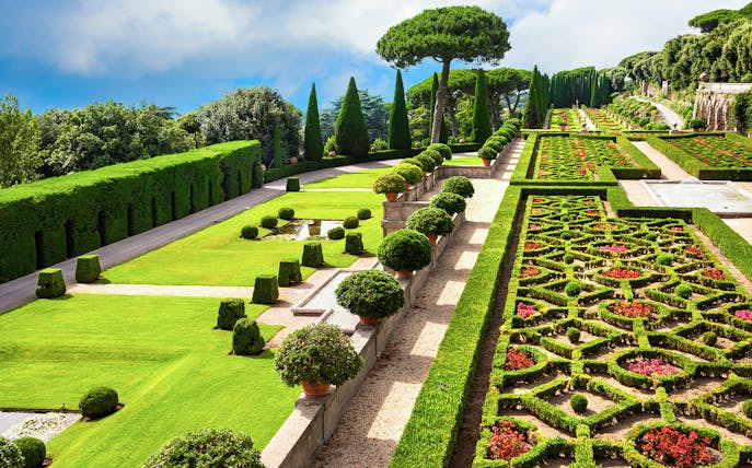Terraced gardens with hedges and flower beds in Castel Gandolfo park, Italy.