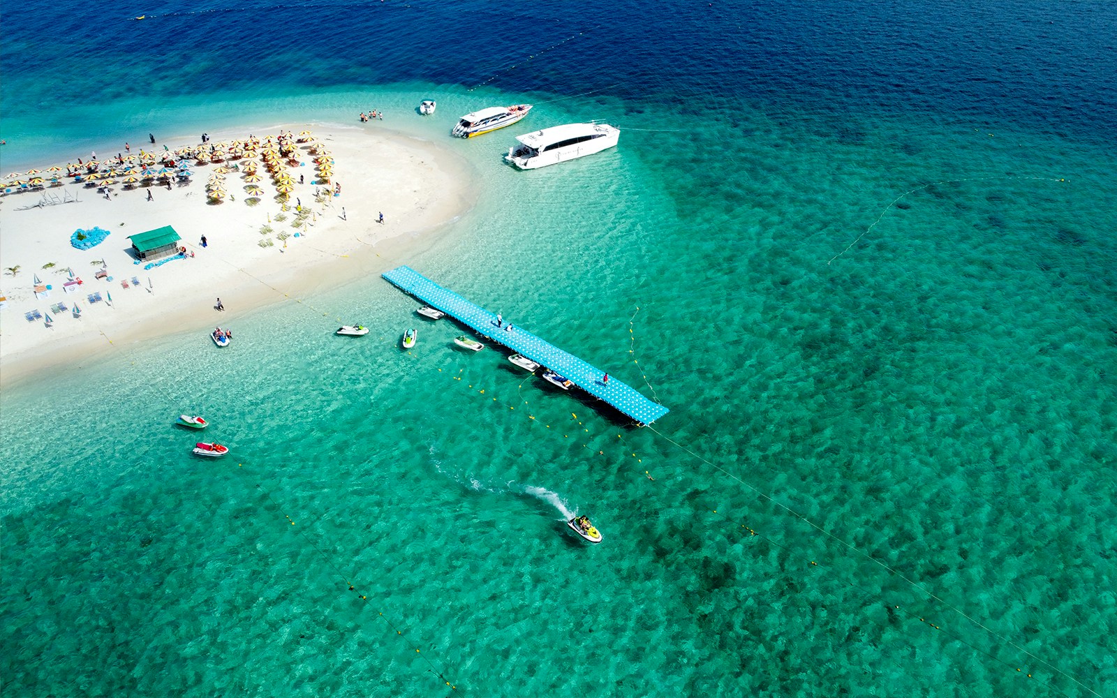 Aerial view of boats docked at a pier on Khai Island beach, Thailand.