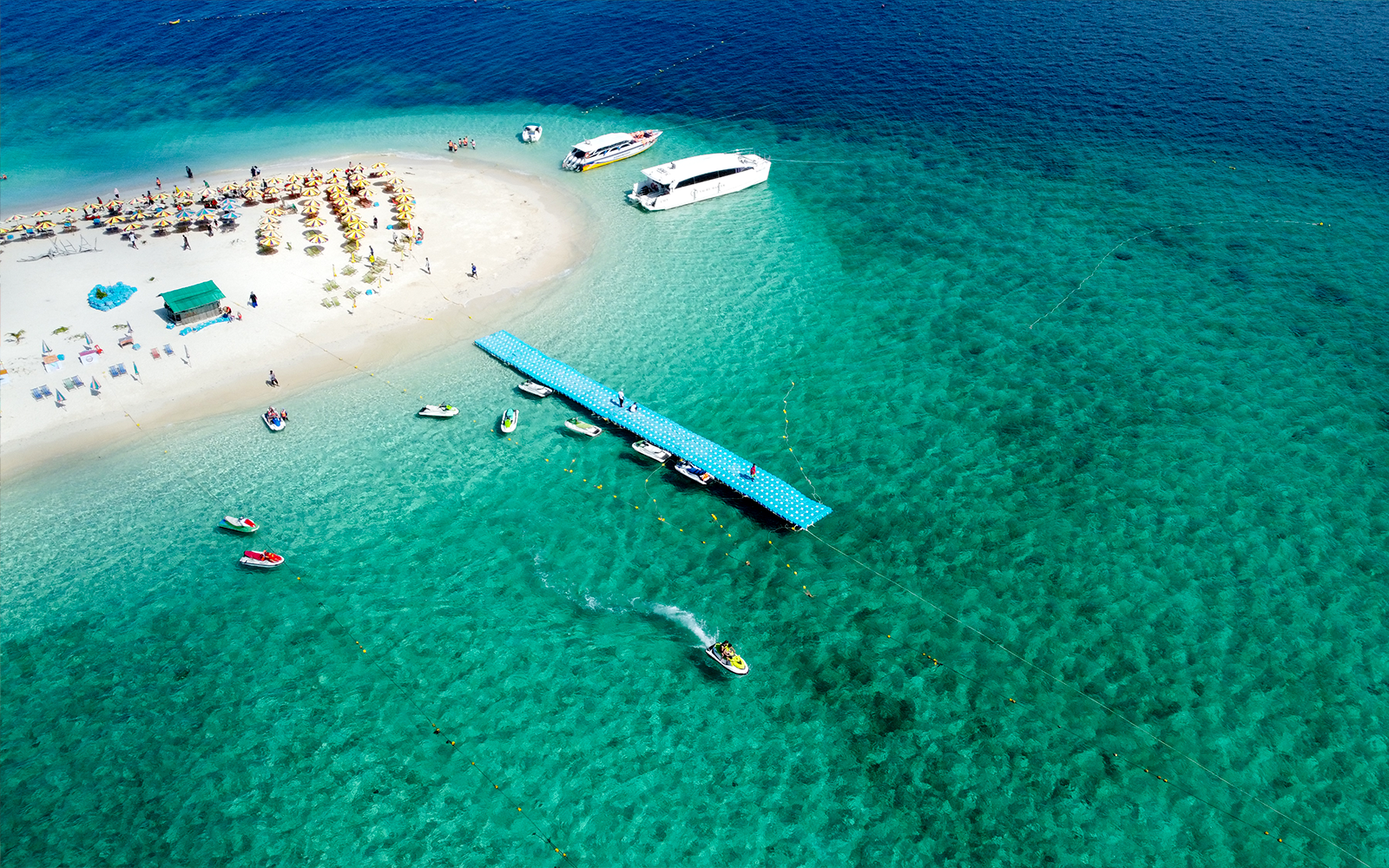 Aerial view of boats docked at a pier on Khai Island beach, Thailand.