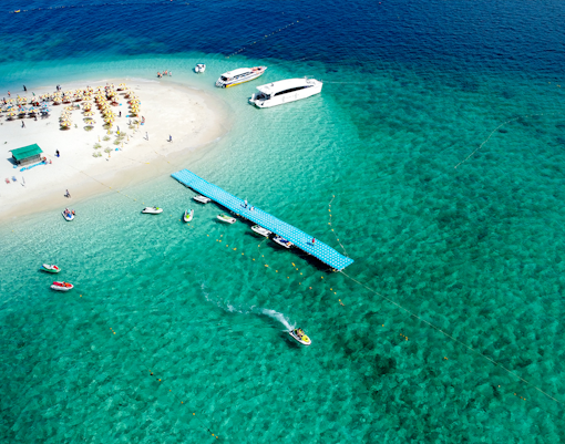 Aerial view of boats docked at a pier on Bamboo Island, Thailand.