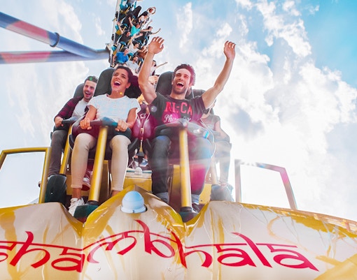 PortAventura theme park roller coaster in Salou, Spain, with vibrant loops and thrill-seekers.