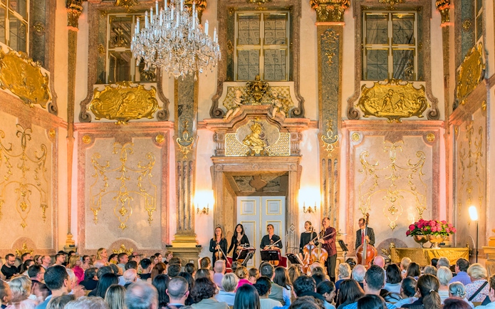 Musicians performing classical music at Mirabell Palace concert hall, Salzburg.