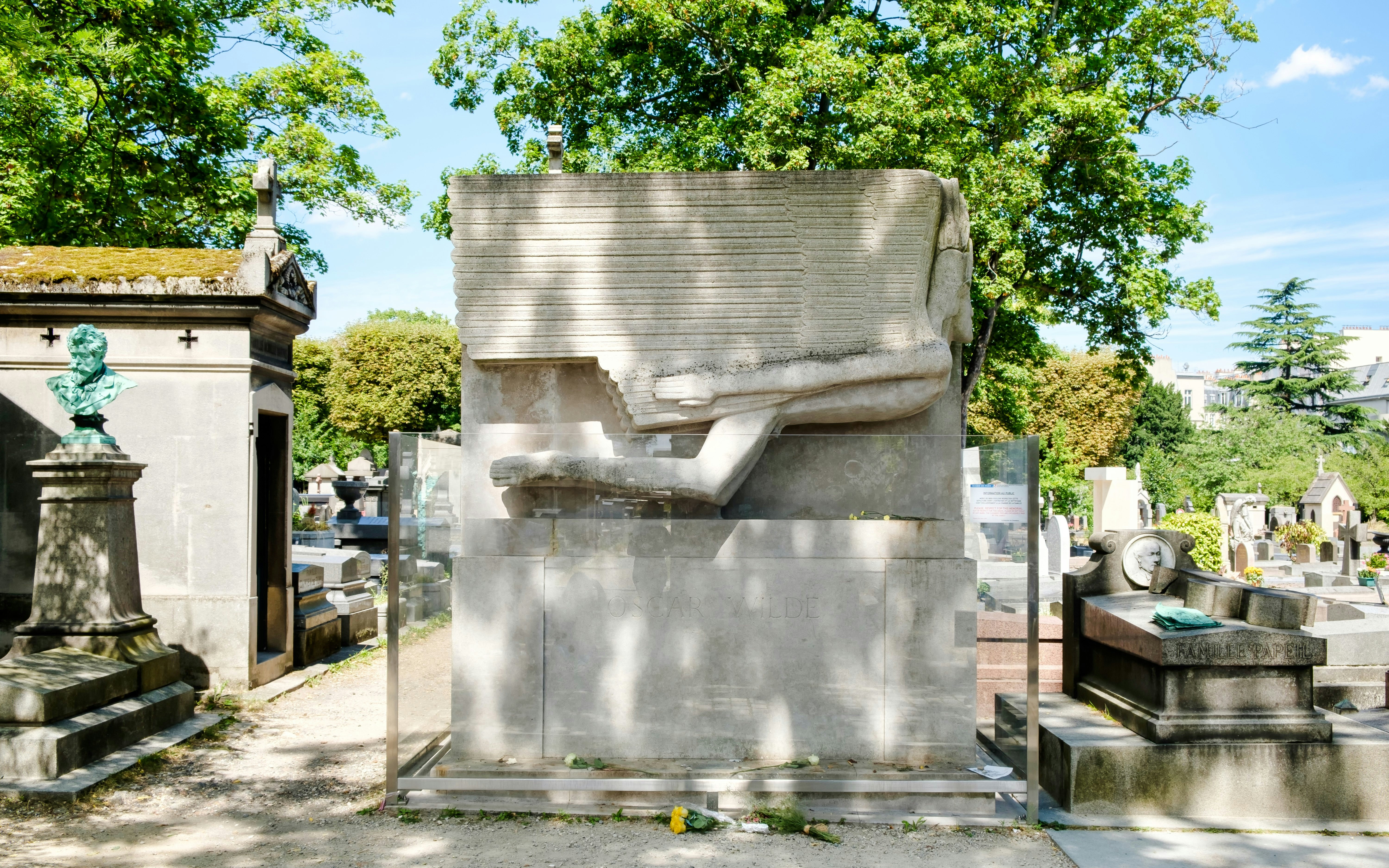 Oscar Wilde's tomb with modernist sculpture at Père Lachaise Cemetery, Paris.